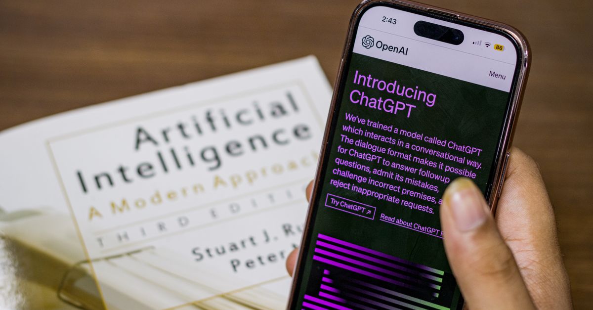 Close-up of a smartphone displaying the ChatGPT app held over an AI textbook.